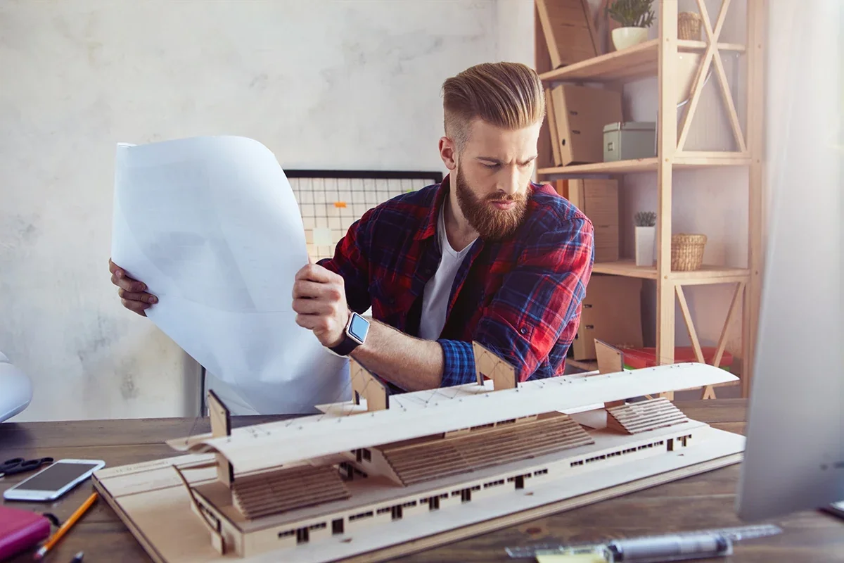 Designer reviewing printed materials to ensure accurate production and execution