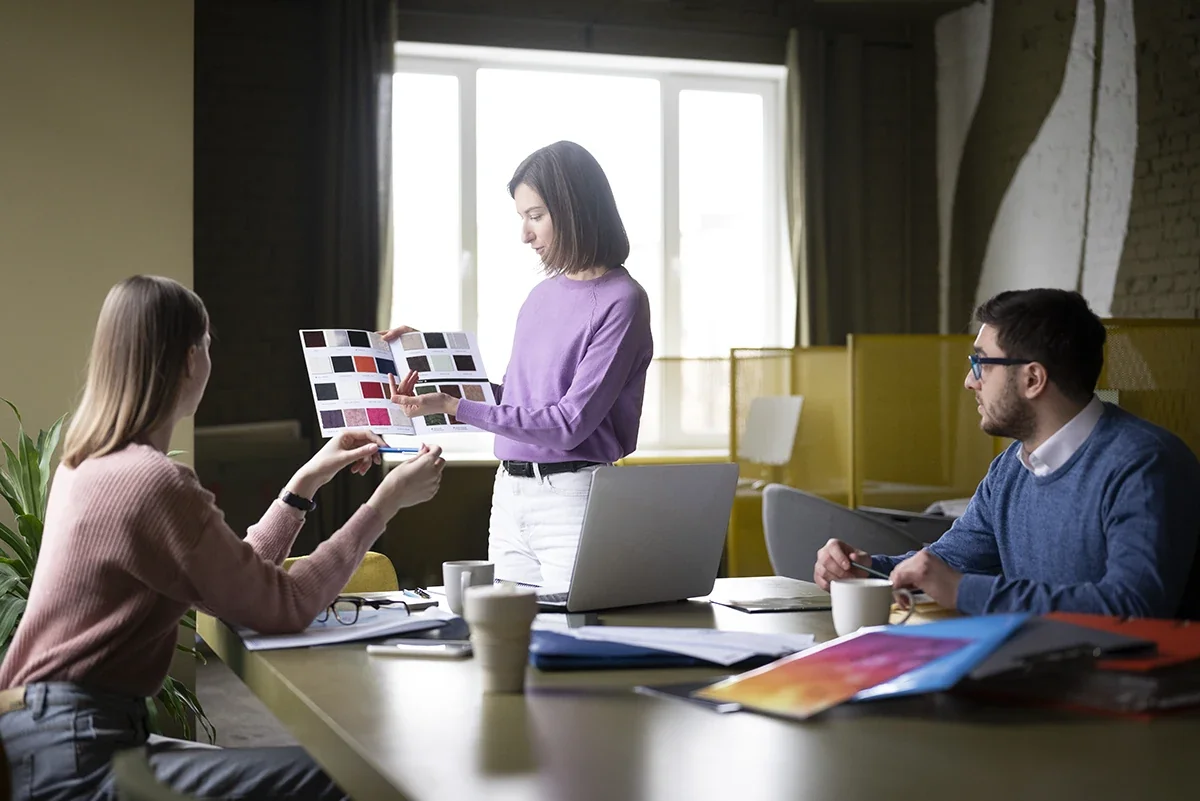 A team in a creative marketing agency discussing color palette and branding design during a strategy meeting