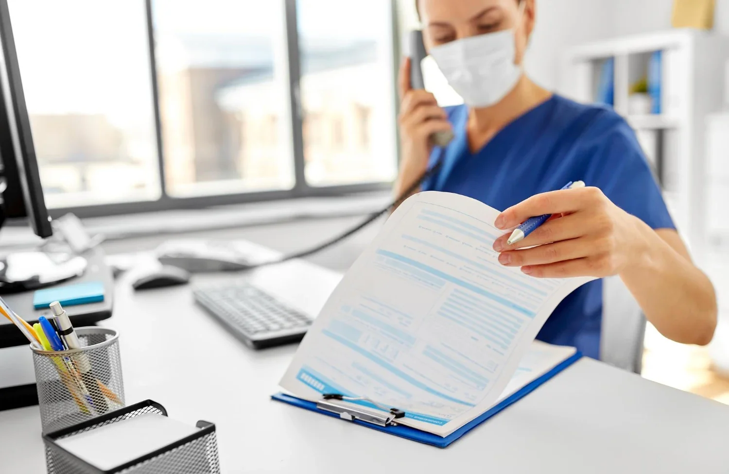 Healthcare worker handling patient-specific documents and personalized communication materials