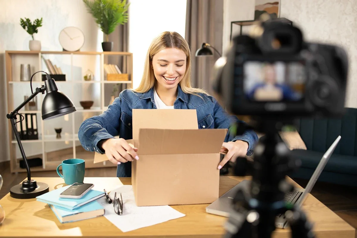 Influencer recording an unboxing video of a promotional influencer package