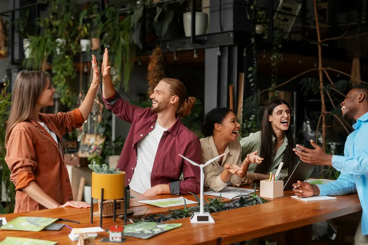 Marketing team collaborating and celebrating ideas for an event marketing campaign.