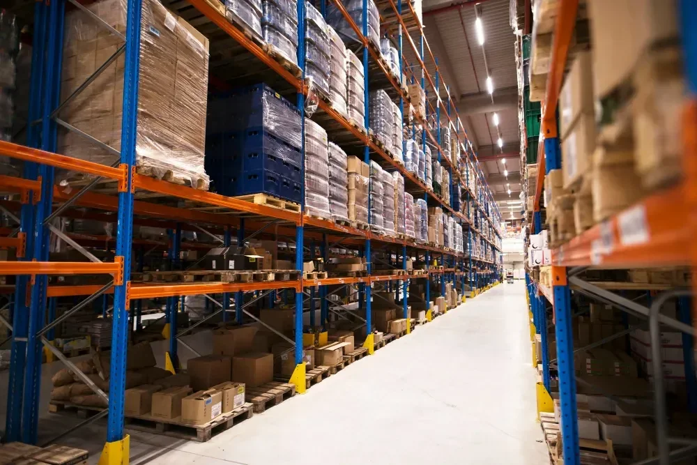 Organized warehouse aisle with pallet racks of shrink-wrapped boxes for storing trade show exhibit materials